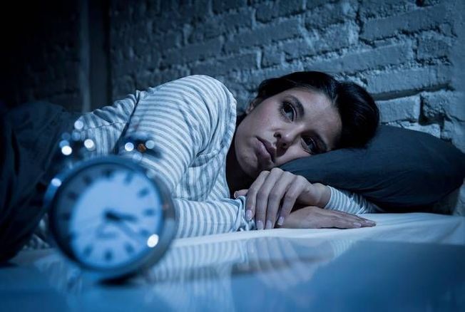 A person lying awake, unable to sleep