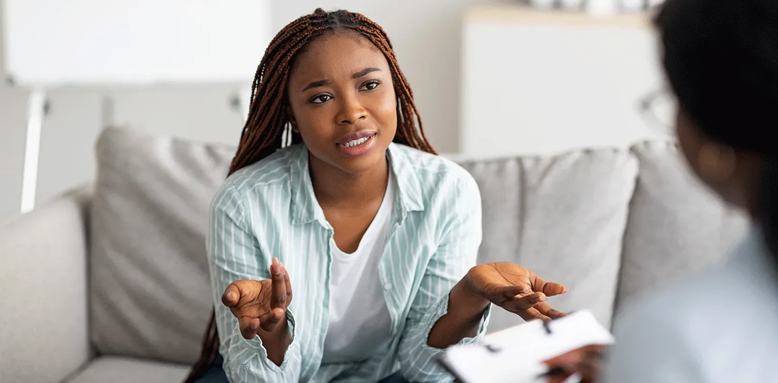 A young woman talking with her therapist during a session